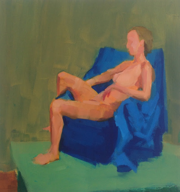 Woman on a blue chair on a green floor